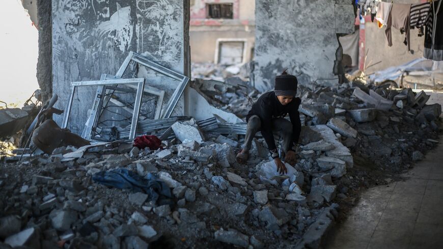 The children of Palestinian Mahmoud Al-Durra, 32 years old, from Gaza City, who was displaced to the city of Rafah in the south of the Gaza Strip after Israeli raids destroyed his house and his wife was killed, play in the ruins on Jan. 31, 2024 in Rafah, Gaza.