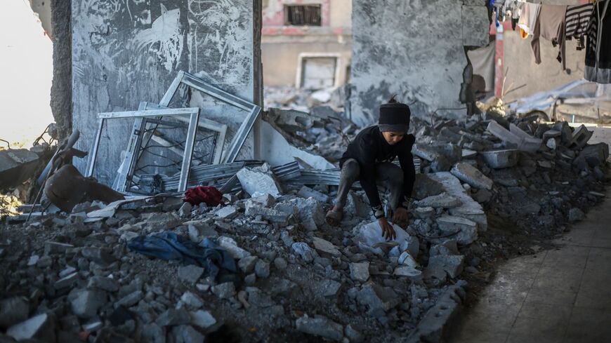 The children of Palestinian Mahmoud Al-Durra, 32 years old, from Gaza City, who was displaced to the city of Rafah in the south of the Gaza Strip after Israeli raids destroyed his house and his wife was killed, play in the ruins on Jan. 31, 2024 in Rafah, Gaza. 