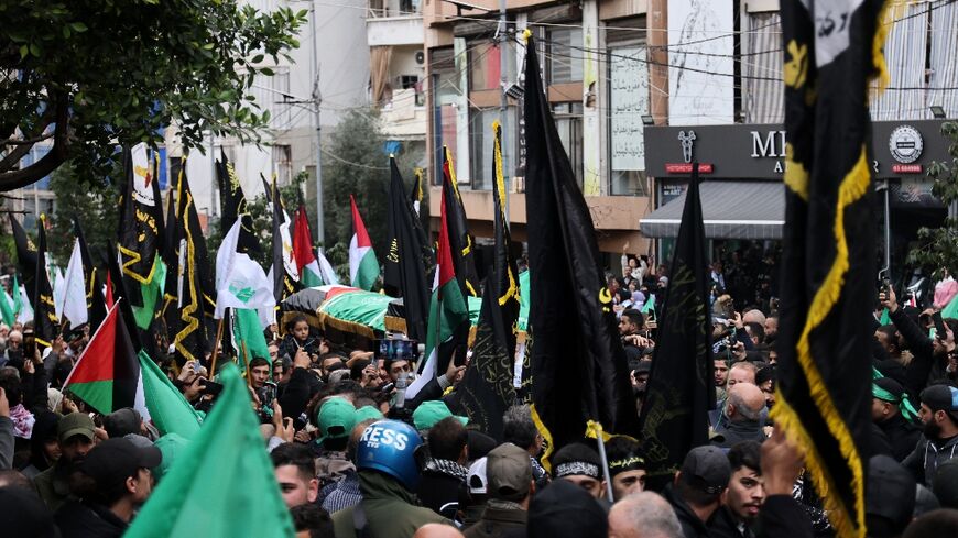 Crowds march in the Beirut funeral procession of Hamas number two Saleh al-Aruri killed along with six other Palestinian militants in a strike on the Lebanese capital blamed on Israel