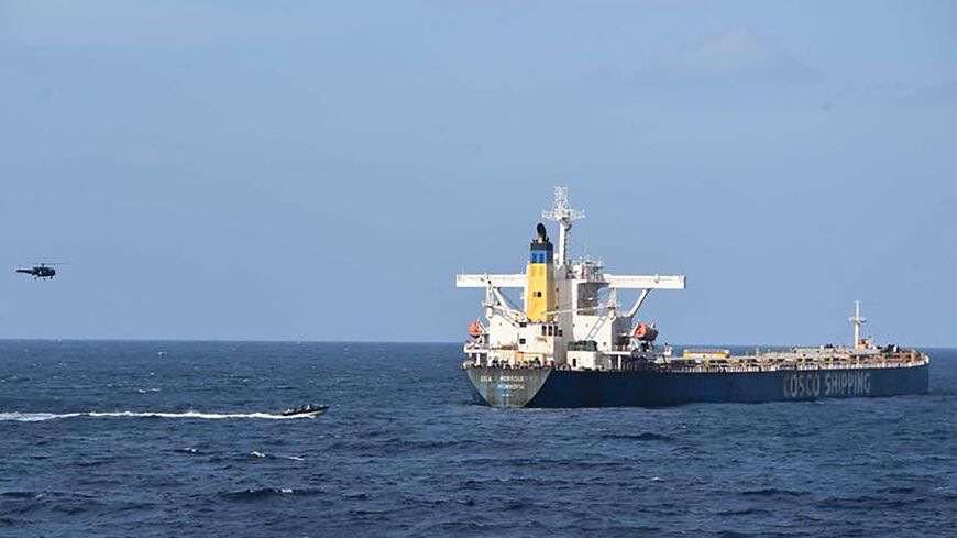 Indian commandos approach the bulk carrier MV Lila Norfolk in the Arabian Sea after an attempted pirate attack, seen in this photo released by the Indian Navy