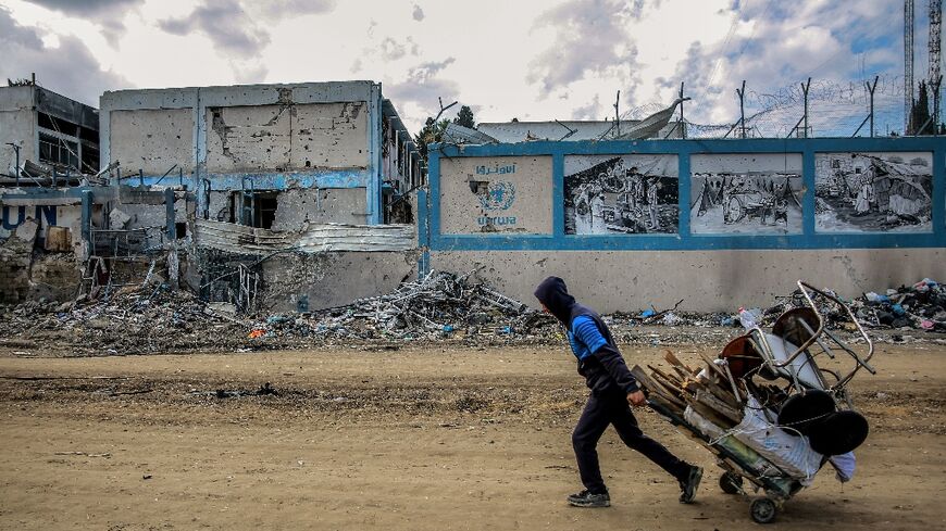 A man walks past the damaged Gaza City headquarters of the United Nations Relief and Works Agency for Palestine Refugees (UNRWA) on February 15, 2024, amid ongoing battles between Israel and the militant group Hamas