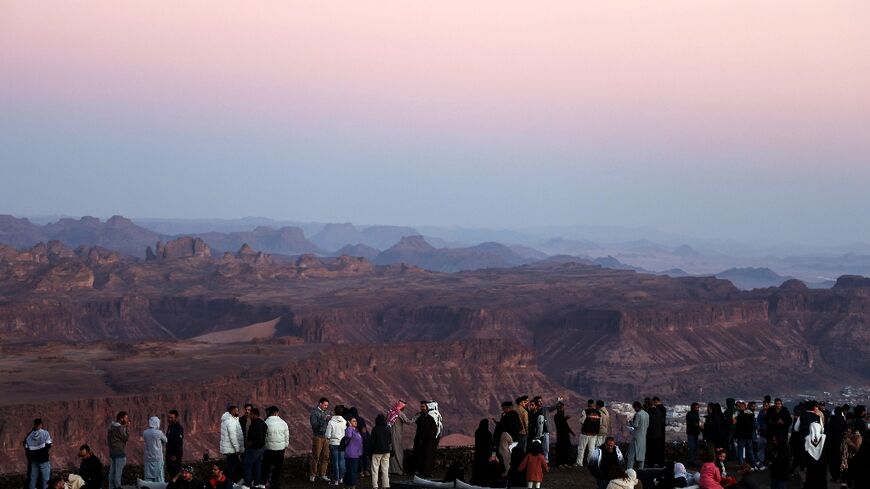 Tourists enjoy panoramic views of the ancient Saudi oasis city of Al-Ula, among a growing number who have beaten a path to the kingdom since it began issuing general tourism visas in 2019