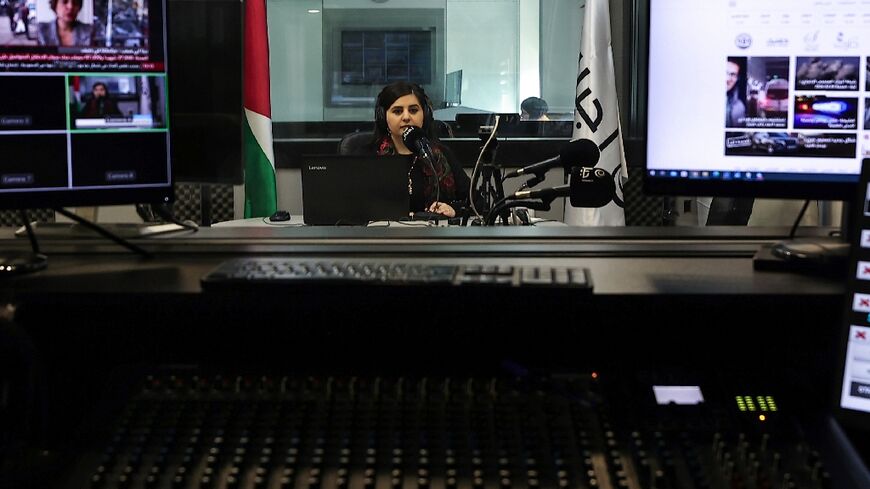 Palestinian radio presenter Maysam Barghouti, 36, sits in the studio at Radio Ajyal