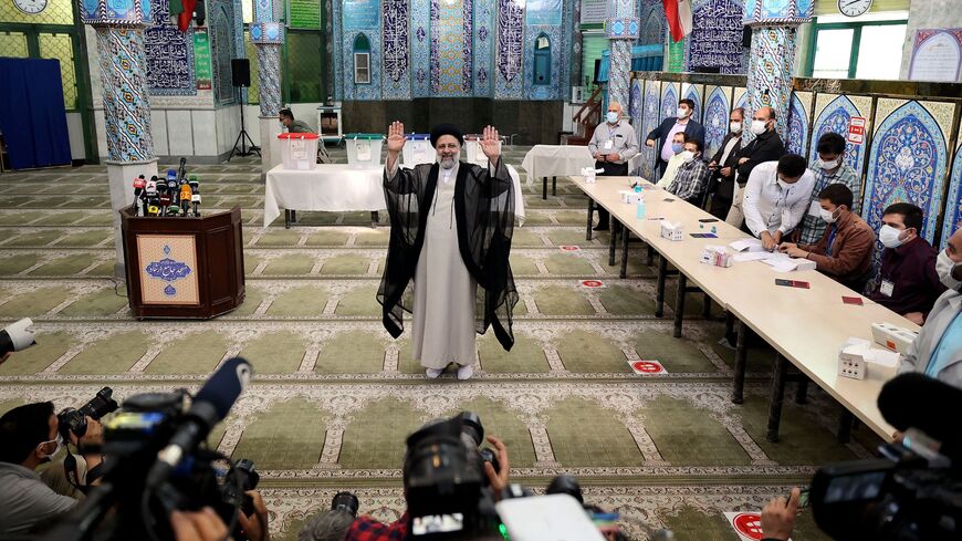 Ebrahim Raisi waves after casting his ballot for presidential election, in Tehran, on June 18, 2021.