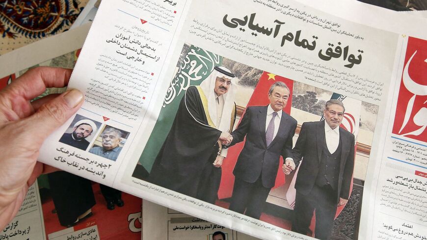 A man in Tehran holds a local newspaper reporting on its front page the China-brokered deal between Iran and Saudi Arabia to restore ties, signed in Beijing the previous day, on March, 11 2023.