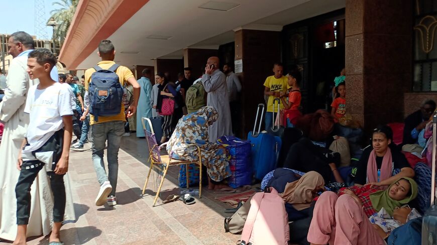 People who fled war-torn Sudan wait at a railway station in the Egyptian city of Aswan on April 28, 2023.