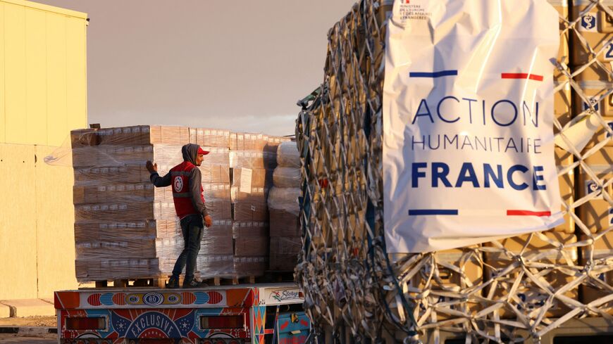 Egyptian Red Crescent members load on a truck humanitarian aid for war-torn Gaza brought by a French air force Airbus A400M cargo aircraft at El-Arish International Airport on November 20, 2023 as Israel has vowed to destroy Gaza's rulers Hamas after the Palestinian militant group carried out the deadliest attack in the country's history on October 7. About 1,200 people, most of them civilians, were killed in Israel during Hamas's October 7 attack and around 240 taken hostage, according to Israeli officials