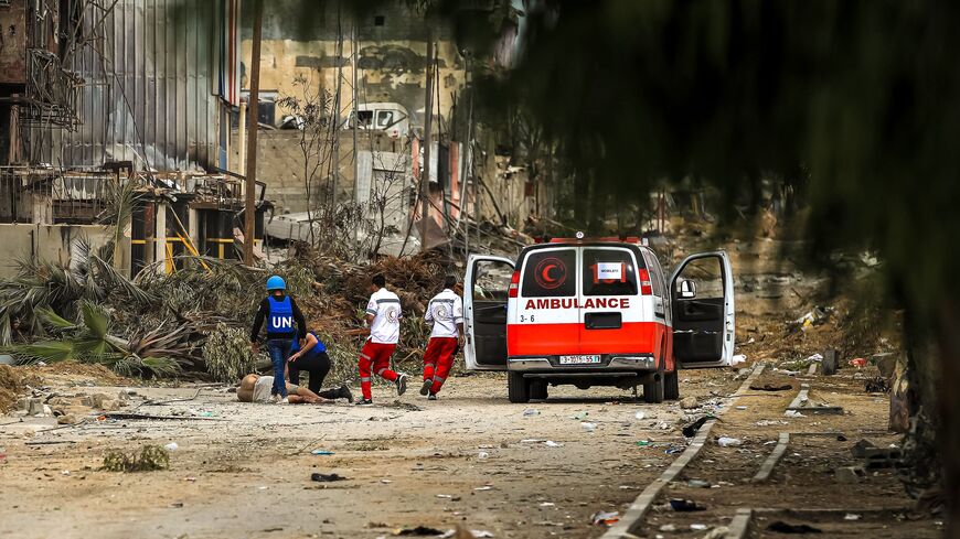 lestinian Red Crescent volunteers and UN staff prepare to assist a Palestinian man reportedly shot by Israeli forces, Zeitoun district, outskirts of Gaza City, Nov. 25, 2023.