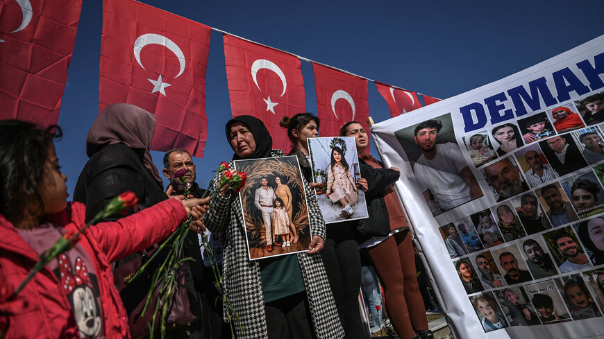Relatives of missing persons hold placards and a banner with their portraits at the Hatay Earthquake Martyrs Cemetery, during a gathering marking the first anniversary of a powerful earthquake that hit the region, in Antakya, southern Turkish Hatay Province, on Feb. 6, 2024.