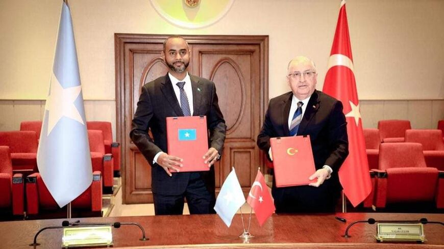 Abdikadir Mohamed Nour (L), the minister of defense of Somalia, signs a security pact with Turkiye’s Minister of Defense Yasar Guler, on Feb. 8, 2024.