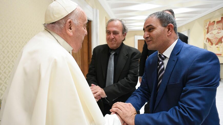 Handout photo from the Vatican showing Pope Francis meeting with Palestinian Bassam Aramin and Israeli Rami Elhanan, who both lost their daughters to violence in the Middle East