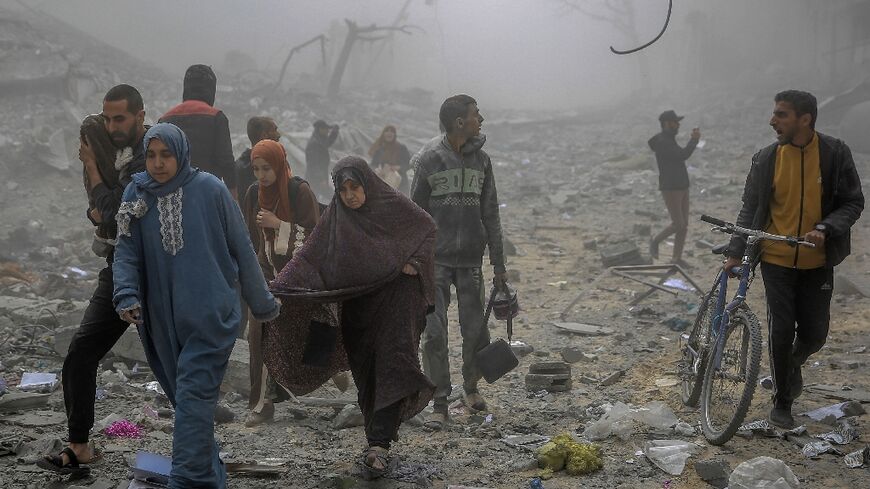 Palestinians flee after Israeli bombardment in central Gaza City on March 18, 2024 amid ongoing battles between Israel and the militant group Hamas