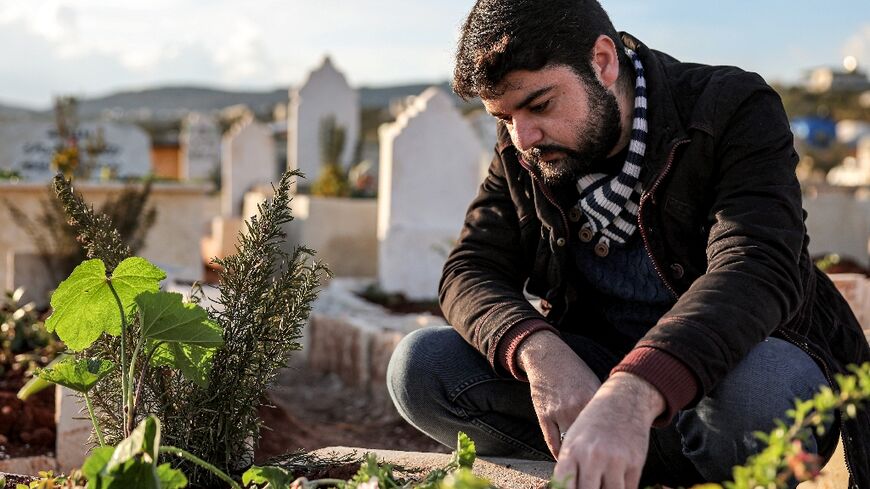 Ahmed al-Hakim by the tomb of his brother, whose death triggered rare protests in Syria's Idlib province