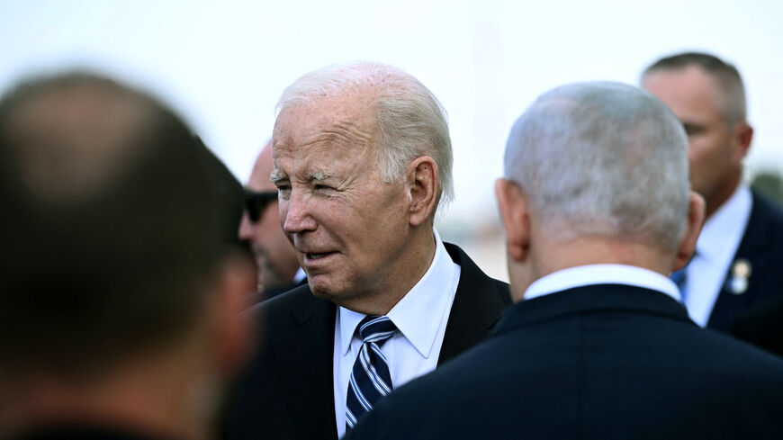 Israel Prime Minister Benjamin Netanyahu (back L) greets US President Joe Biden upon his arrival at Tel Aviv's Ben Gurion airport on October 18, 2023, amid the ongoing battles between Israel and the Palestinian group Hamas. Biden landed in Israel on October 18, on a solidarity visit following Hamas attacks that have led to major Israeli reprisals. (Photo by Brendan Smialowski / AFP) (Photo by BRENDAN SMIALOWSKI/AFP via Getty Images)