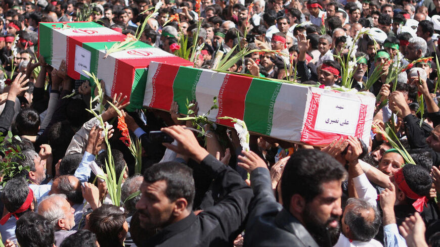 Iranians carry the coffins at the Shah Cheragh shrine of Shiraz on April 15, 2008 during the funeral of the people who were killed in a mosque blast on April 12 in the southern city of Shiraz.