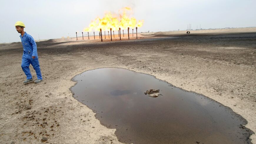 An engineer walks across the Zubair oil field in southern Iraq on Jan. 21, 2010.