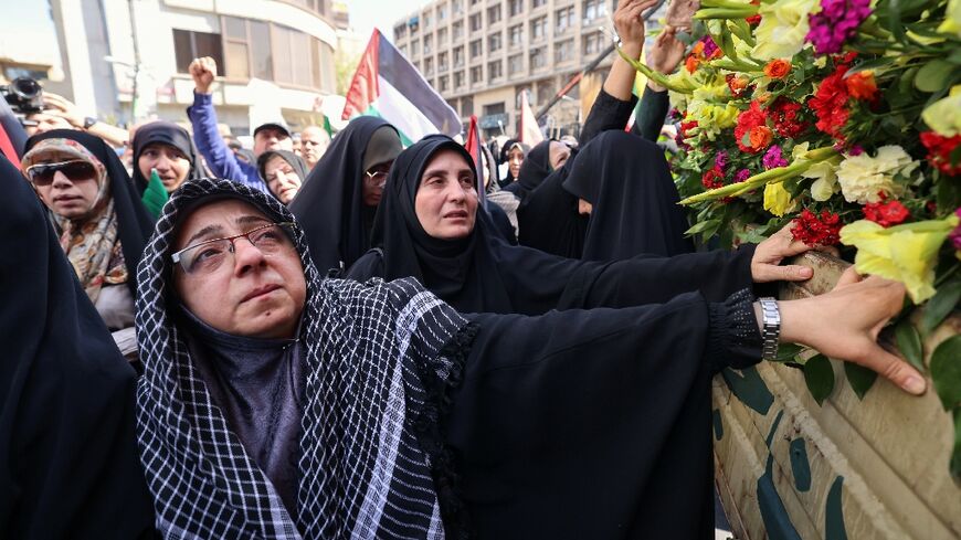 Iranians attend the funeral in Tehran of the seven Islamic Revolutionary Guard Corps members