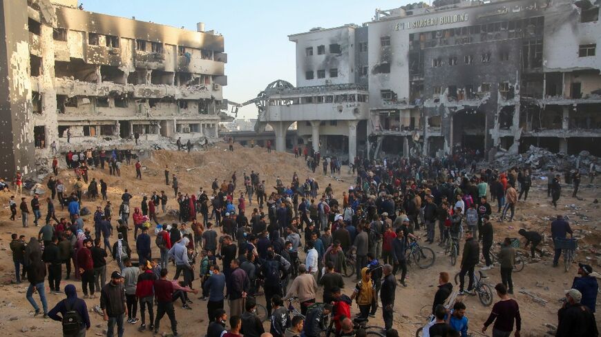 Palestinians inspect the damage at Gaza's Al-Shifa hospital after the Israeli military withdrew from the complex on April 1, 2024