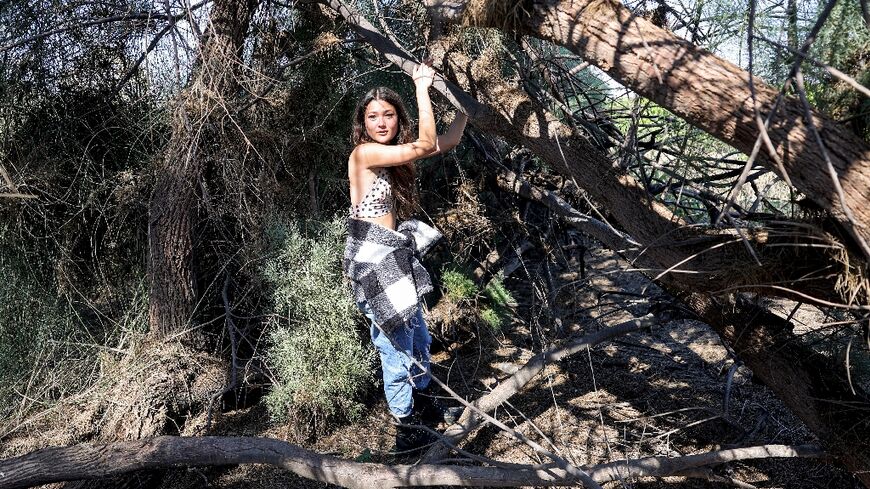 Hannah Zedek, one of the survivors of the October 7 attack on the Supernova music festival by Palestinian militants, shows journalists her hiding spot 