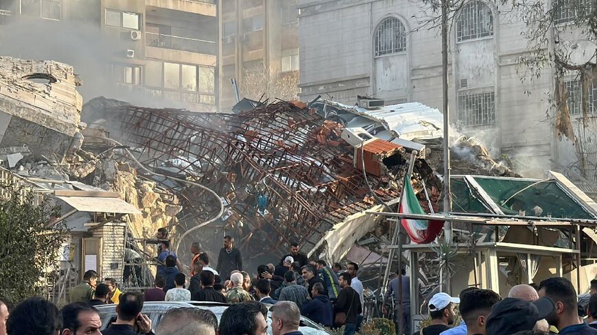 Emergency and security personnel gather at the site of strikes which hit a building adjacent to the Iranian embassy in Syria's capital Damascus, on April 1, 2024