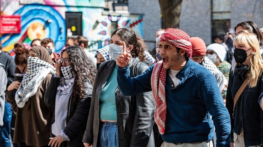 Pro-Palestinian protesters stand in front of a police barricade at Northeastern University in Boston, Massachusetts, on April 27, 2024