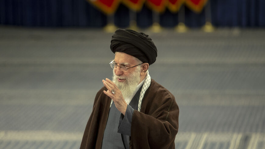 TEHRAN, IRAN - MARCH 01: Iran's supreme leader Ayatollah Ali Khamenei (R) arrives to cast his ballots during the parliamentary and key clerical body elections at a polling station on March 1, 2024 in Tehran, Iran. Iranians are voting in parliamentary elections and will also cast ballots for the Assembly of Experts, which selects and nominally oversees the work of Iran's supreme leader. (Photo by Majid Saeedi/Getty Images)