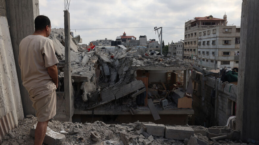 TOPSHOT - A Palestinian looks at the damage to buildings after Israeli bombardment in Rafah in the southern Gaza Strip, on April 29, 2024 amid the ongoing conflict between Israel and the Palestinian militant group Hamas. (Photo by AFP) (Photo by -/AFP via Getty Images)