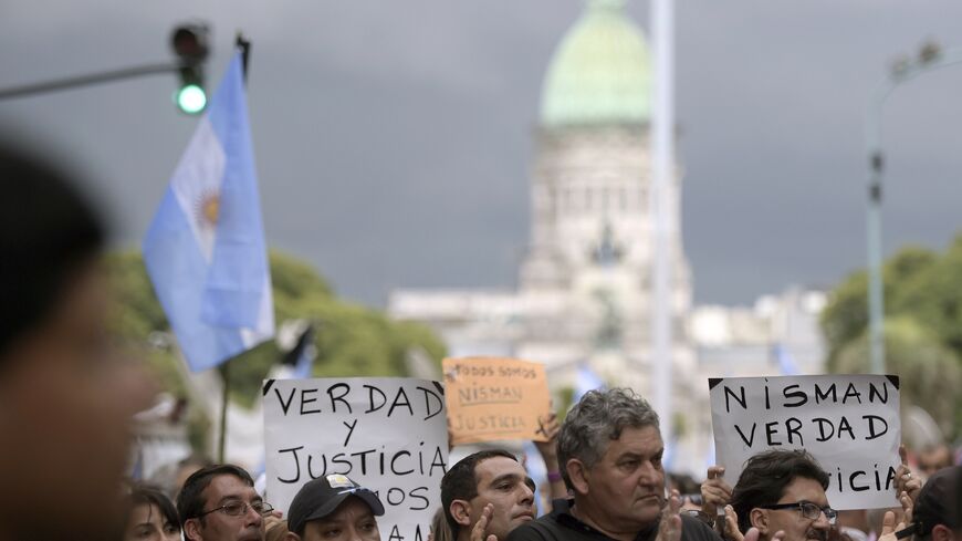 People rally near the Congress building before marching along Avenida de Mayo avenue in the "Marcha del silencio"(March of Silence) called by Argentine prosecutors in memory of their late colleague Alberto Nisman in Buenos Aires on February 18, 2015. President Cristina Kirchner urged Argentines to be on guard Wednesday ahead of a mass protest over the mysterious death of Nisman who had accused her of a cover-up in his probe of a 1994 bombing. Nisman was found in his Buenos Aires apartment with a bullet thro