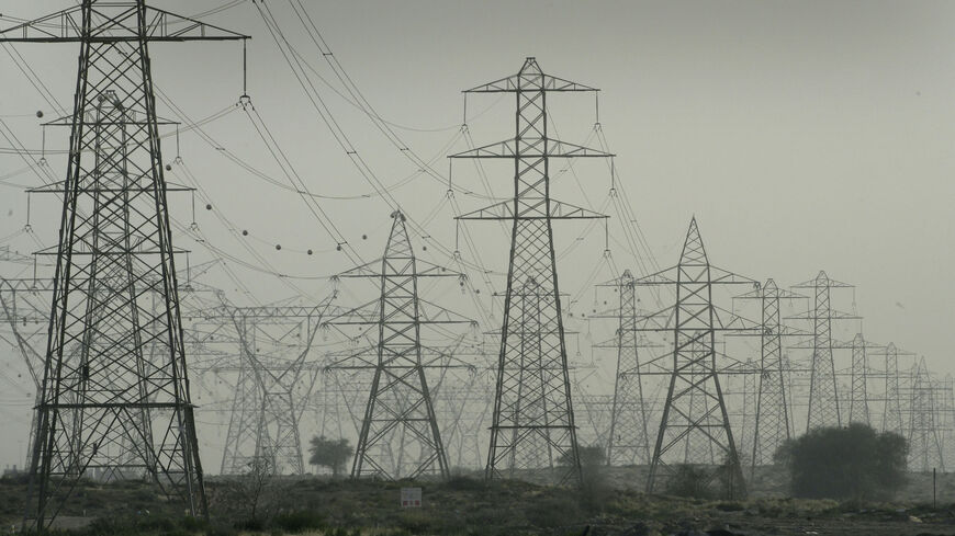 DUBAI, UNITED ARAB EMIRATES - APRIL 02: The many pylons that provide power to Dubai are seen in the desert on April 2, 2007 in Dubai, United Arab Emirates. Commerce and Industry is currently thriving in Dubai and Indian and Pakistani expatriot workers are the backbone of the workforce, sending money back to their families at home. (Photo by Chris Jackson/Getty Images)