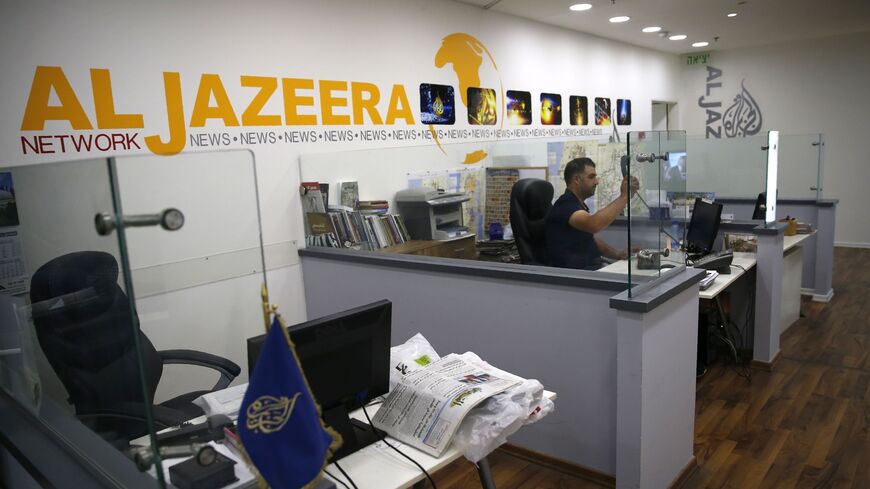 An employee of the Qatar-based news network and TV channel Al Jazeera is seen at the channel's Jerusalem office on July 31, 2017.