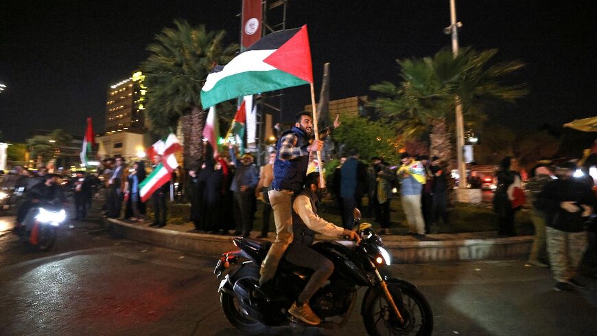 Hundreds celebrate Iran's unprecedented attack on its arch enemy on the streets of Tehran