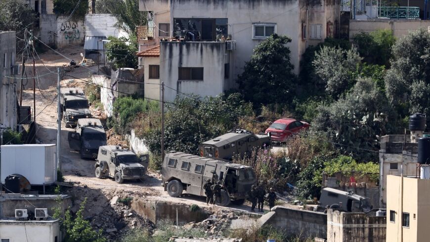 Israeli soldiers line up during a raid in the Nur Shams refugee camp in the occupied West Bank