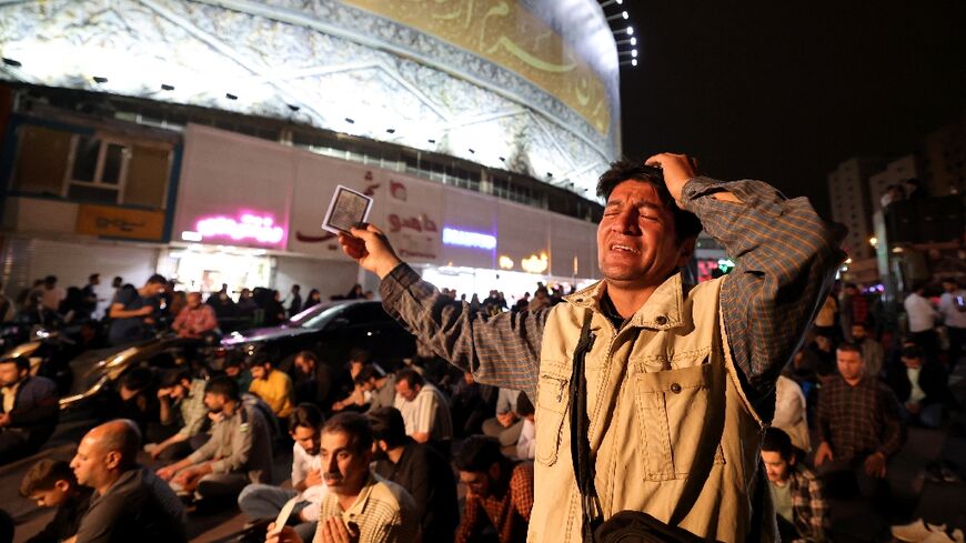 Iranians pray for President Ebrahim Raisi and Foreign Minister Hossein Amir-Abdollahian in Valiasr Square in central Tehran on May 19, 2024