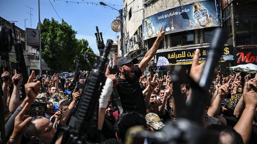 Armed Palestinian militants attend a group funeral of people killed in a raid by Israeli forces in Jenin, in the occupied West Bank