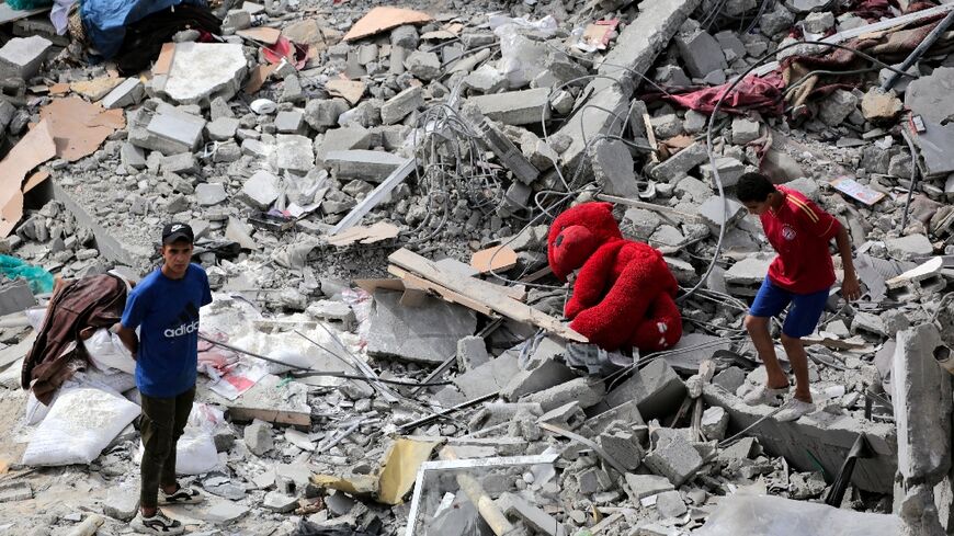 Palestinians inspect the rubble of a residential building destroyed by an Israeli strike on Al-Zawayda in central Gaza