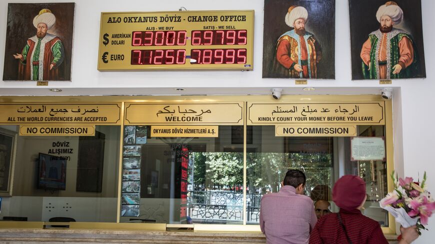 People exchange money at a currency exchange office on Aug. 13, 2018, in Istanbul, Turkey. 