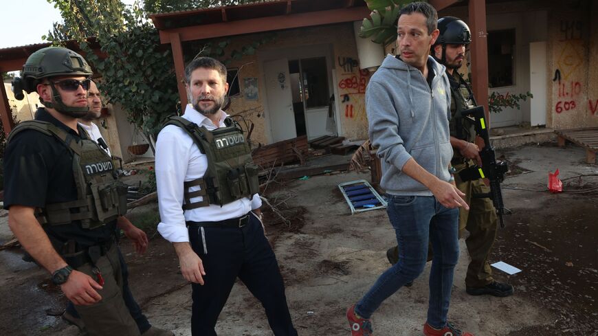 Far-right Israeli Finance Minister Bezalel Smotrich walks with soldiers during a visit to Kibbutz Kfar Aza near the border with the Gaza Strip on Nov. 14, 2023, in the aftermath of an attack by Palestinian militants on Oct. 7.