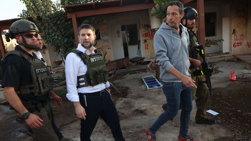 Far-right Israeli Finance Minister Bezalel Smotrich walks with soldiers during a visit to Kibbutz Kfar Aza near the border with the Gaza Strip on Nov. 14, 2023, in the aftermath of an attack by Palestinian militants on Oct. 7. 