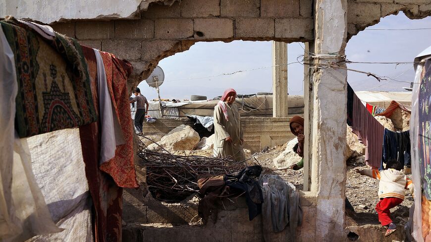 Displaced Syrians walk through a makeshift camp for Syrian refugees only miles from the border with Syria in the Bekaa Valley on Nov. 12, 2013, in Majdal Anjar, Lebanon. 