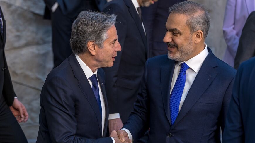 Antony J. Blinken, United States Secretary of State, shakes hands with the Turkish Minister of Foreign Affairs Hakan Fidan before posing for the official press photo on the first day of the NATO foreign ministers' meeting at the NATO headquarters on April 03, 2024, in Brussels, Belgium.
