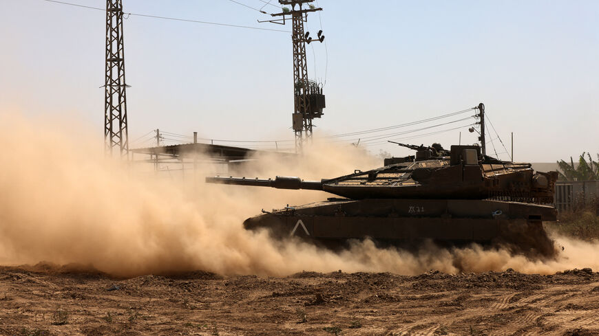 An Israel tank rolls near the border with the Gaza Strip on May 2, 2024, amid the ongoing conflict between Israel and the Palestinian Hamas movement. (Photo by Menahem KAHANA / AFP) (Photo by MENAHEM KAHANA/AFP via Getty Images)