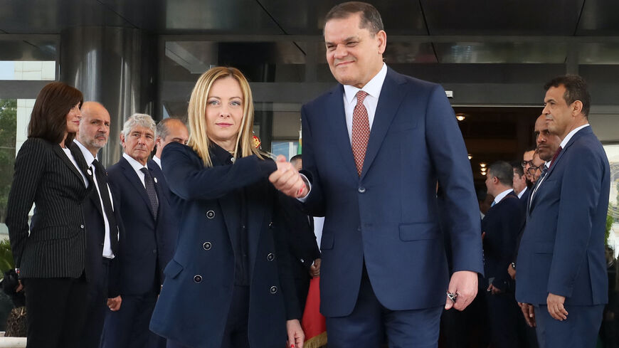 Libya's interim Prime Minister Abdulhamid Dbeibah (R) welcomes Italy's Prime Minister Giorgia Meloni as she arrives for a meeting in Tripoli on May 7, 2024.