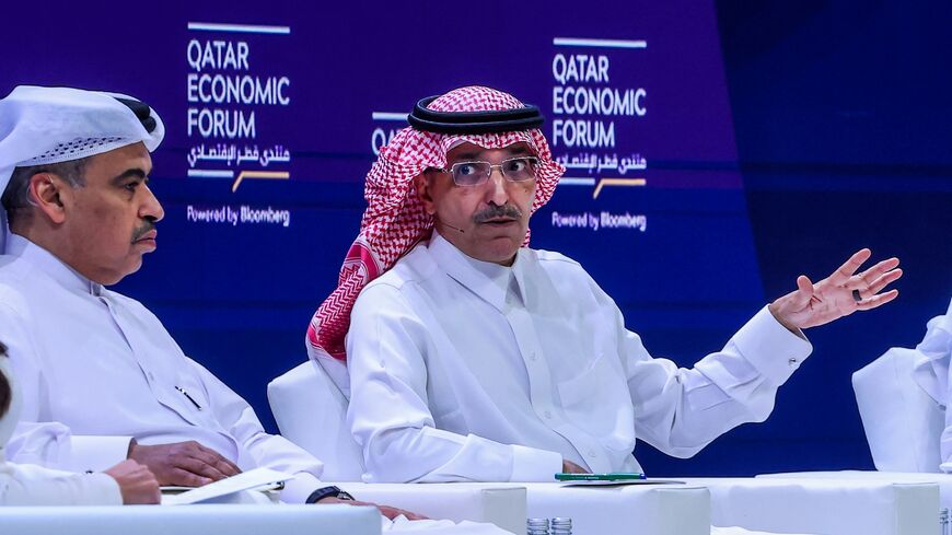 Qatar's Finance Minister Ali bin Ahmed Al Kuwari (L) listens as his Saudi counterpart Mohammed Al-Jadaan speaks during a session at the Qatar Economic Forum in Doha on May 14, 2024. 