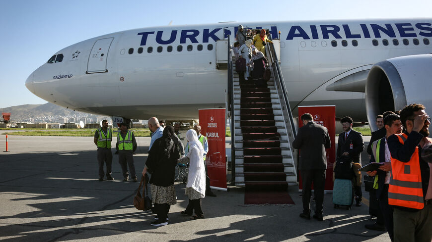 Passengers getting off a Turkish airline plane after it landed at the Kabul International Airport in Kabul on May 21, 2024.
