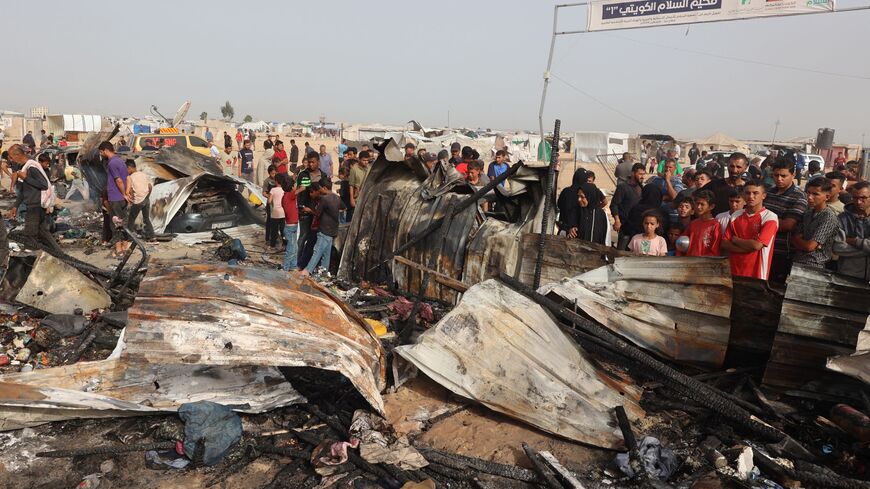 Palestinians gather at the site of an Israeli strike on a camp for internally displaced people in Rafah on May 27, 2024.