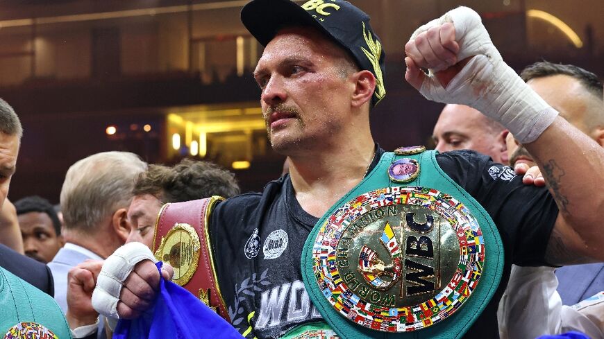 Ukraine's Oleksandr Usyk celebrates his victory over Britain's Tyson Fury for the undisputed heavyweight world title