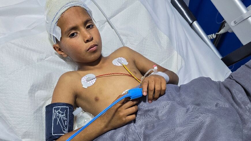 Mohamed Farhat, 10, is treated in a Tripoli hospital for injuries caused by an unexploded ordnance