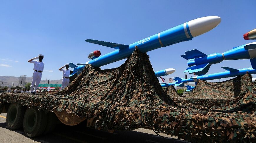 Huthi soldiers stand guard on a missile carrier during a military parade in September 2023