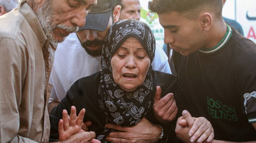 A Palestinian woman mourns her relative, killed in an Israeli strike in central Gaza's Deir al-Balah