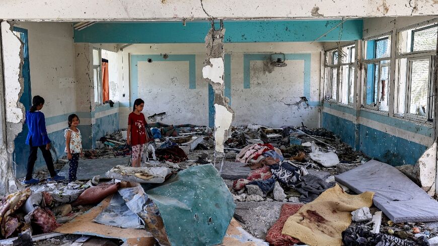 Gaza children inspect damage to a UN-run school being used as a shelter